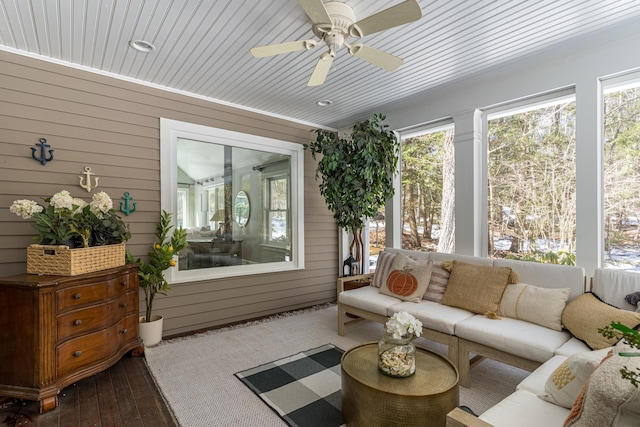 sunroom / solarium with a ceiling fan