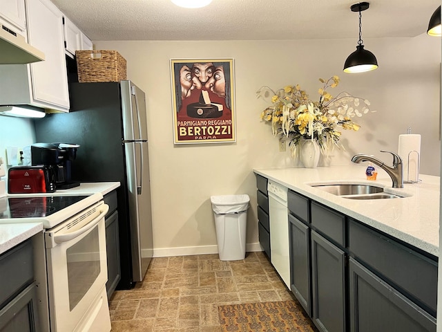 kitchen featuring light countertops, white range with electric cooktop, a sink, and baseboards