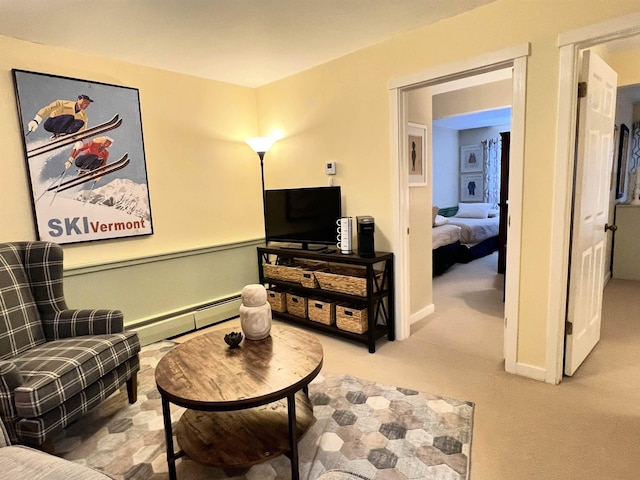 living area featuring carpet floors, baseboard heating, and baseboards