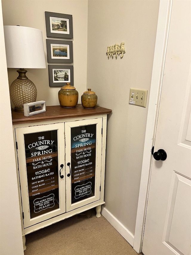 interior space with baseboards and carpet flooring