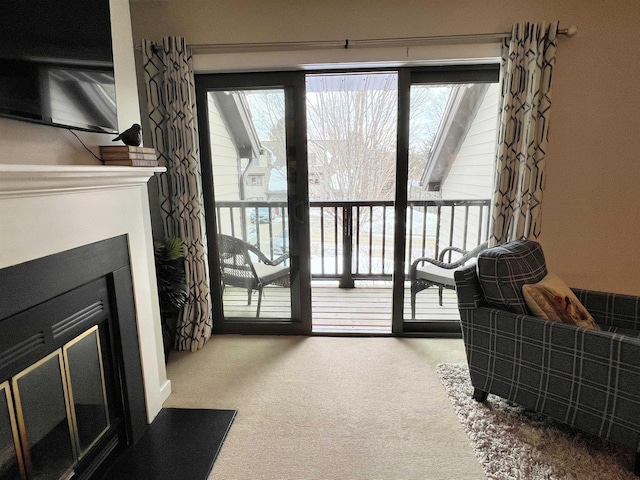 interior space with carpet floors and a glass covered fireplace