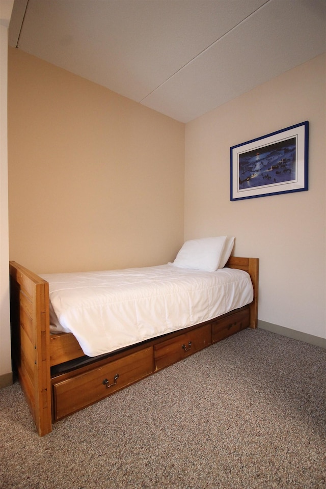 bedroom featuring carpet and baseboards