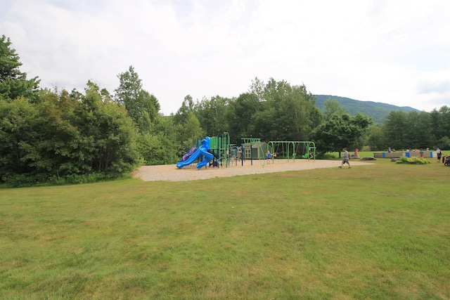 community play area with a lawn and a mountain view