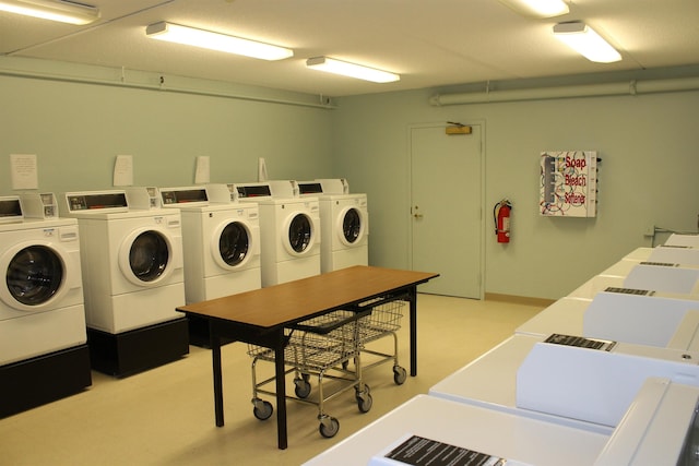 community laundry room with washer and clothes dryer