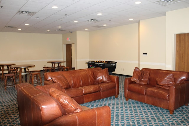 carpeted living room with visible vents, a drop ceiling, and recessed lighting