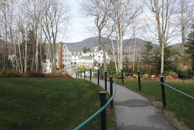 surrounding community featuring a mountain view and a yard