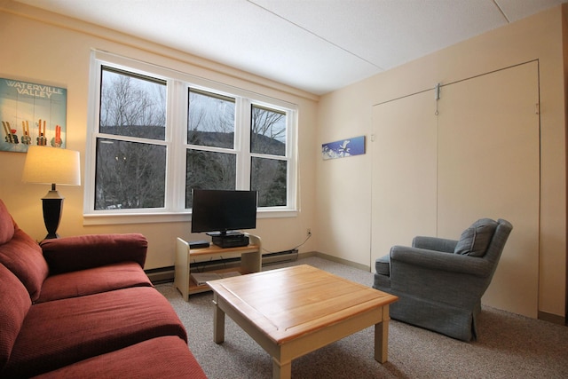 living area with baseboard heating and carpet