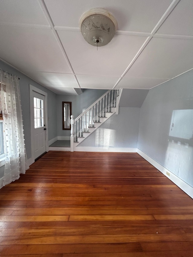 entrance foyer with hardwood / wood-style flooring, baseboards, and stairway