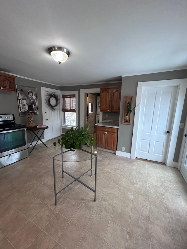 living area with crown molding, baseboards, and light tile patterned floors