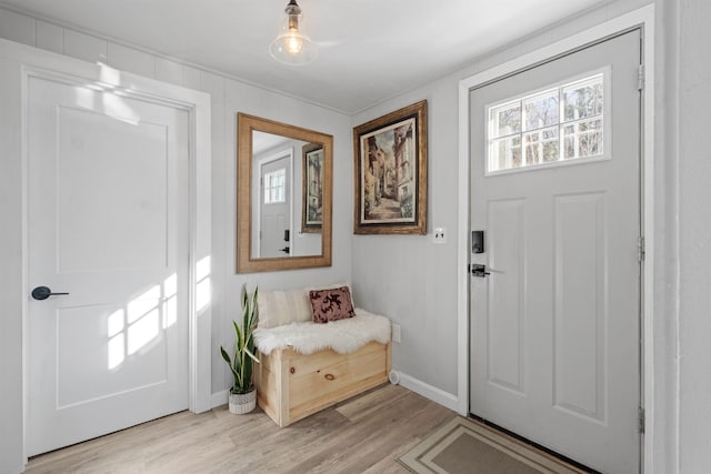 entryway with light wood-style floors, baseboards, and a healthy amount of sunlight