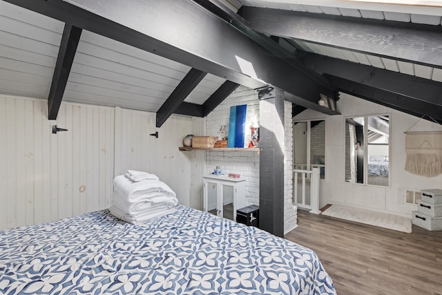 bedroom featuring wooden walls, vaulted ceiling with beams, visible vents, and wood finished floors