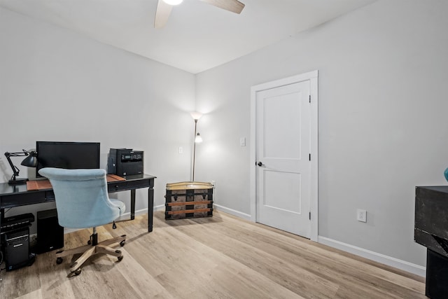 office area with a ceiling fan, wood finished floors, and baseboards