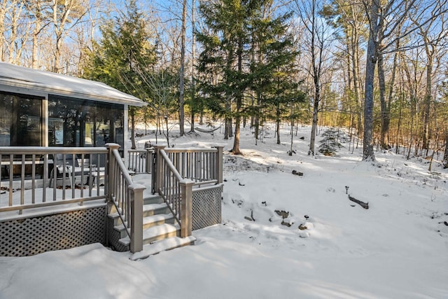 yard covered in snow with a deck