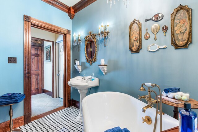 full bathroom with a freestanding bath, baseboards, tile patterned flooring, and crown molding