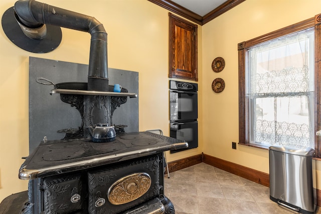 room details featuring a wood stove, dobule oven black, baseboards, and ornamental molding