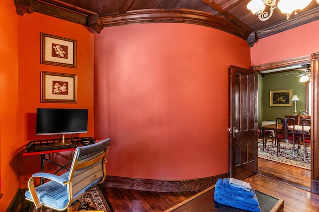 office space with wood-type flooring, crown molding, baseboards, and a notable chandelier