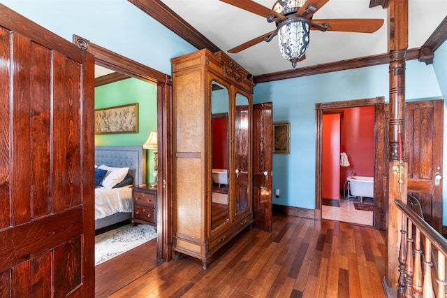 hall with baseboards, hardwood / wood-style floors, and crown molding