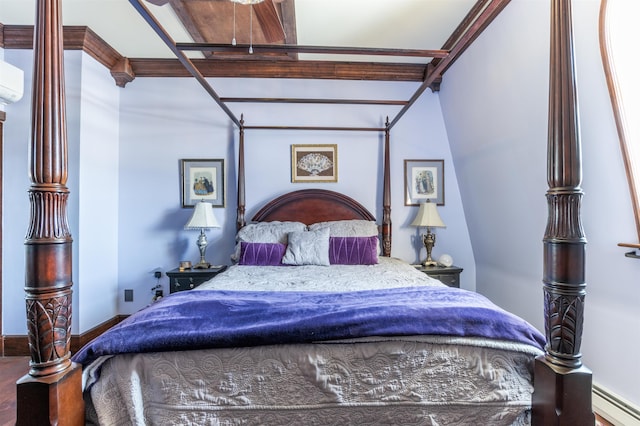 bedroom with a baseboard radiator, baseboards, an AC wall unit, and wood finished floors