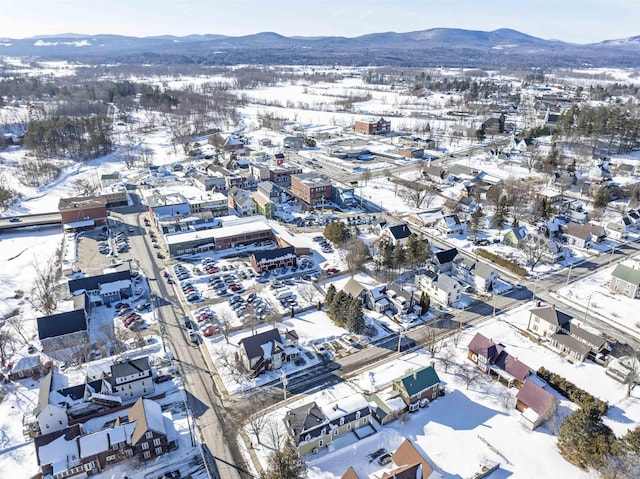 snowy aerial view featuring a mountain view