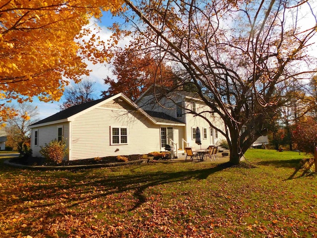 view of home's exterior featuring entry steps, a lawn, and a patio area