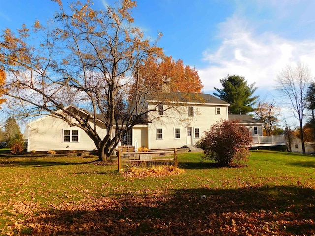 rear view of property with a yard