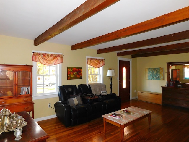 living room featuring beamed ceiling, baseboards, and wood finished floors