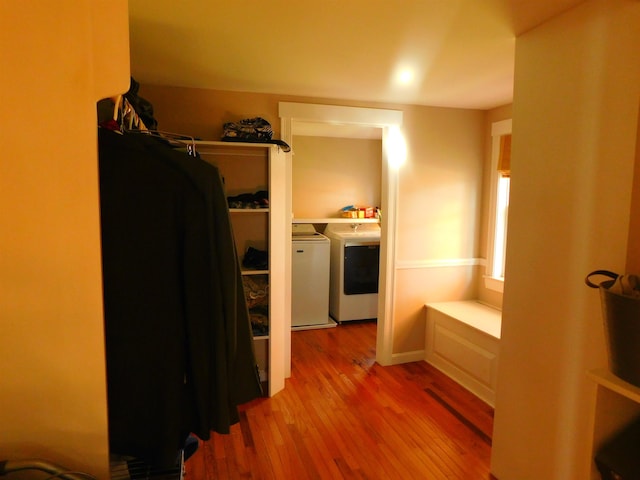 spacious closet with washer and dryer and wood finished floors