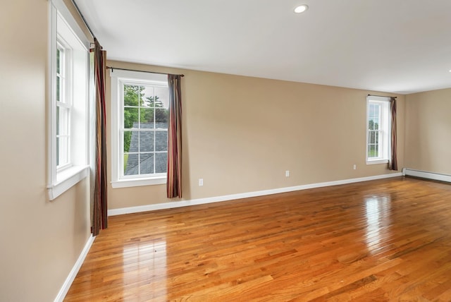 26 Hilltop Dr, Wakefield, NH 03872 - spare room featuring healthy amount of natural light, light wood-type flooring, baseboards, a baseboard radiator, and recessed lighting