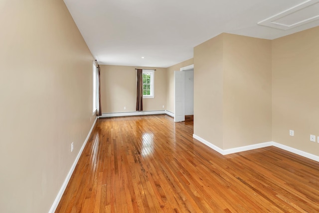26 Hilltop Dr, Wakefield, NH 03872 - unfurnished room with baseboards, a baseboard radiator, and light wood-type flooring