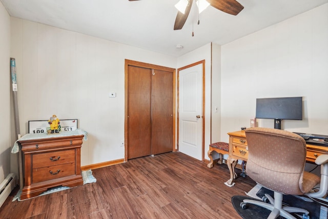 office with dark wood-style floors, baseboards, a baseboard heating unit, and a ceiling fan