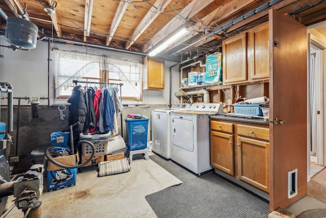 clothes washing area with cabinet space and washing machine and clothes dryer