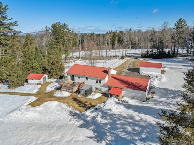 snowy aerial view with a view of trees