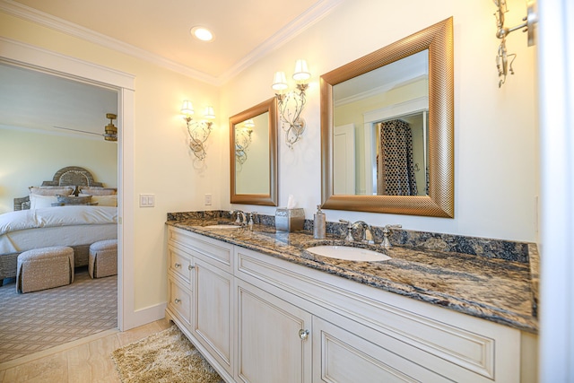 bathroom featuring double vanity, a sink, and crown molding