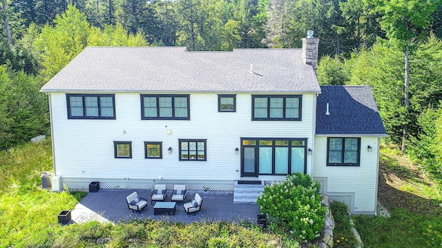 exterior space with entry steps, a shingled roof, a patio, a chimney, and outdoor lounge area