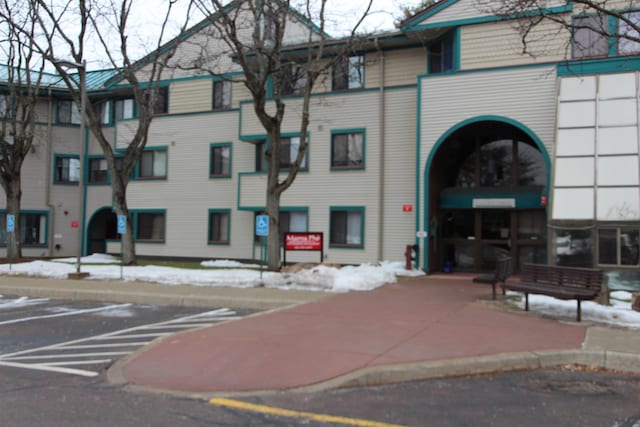 view of building exterior with uncovered parking