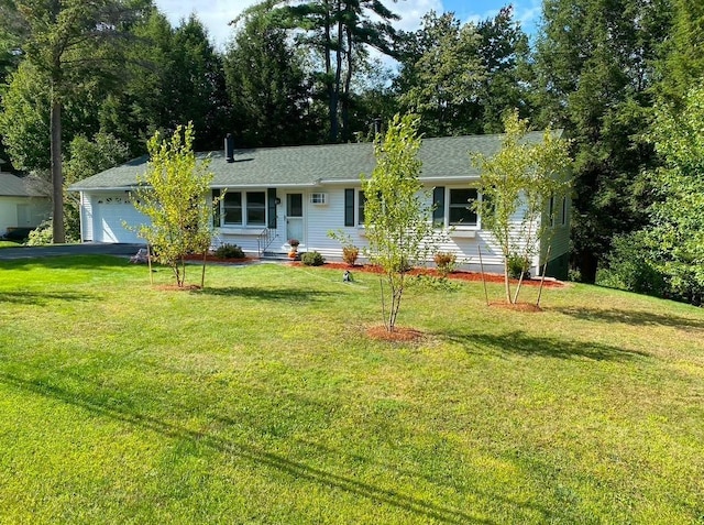 ranch-style home featuring a garage and a front lawn