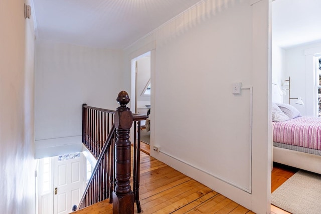 staircase featuring wood-type flooring and baseboards