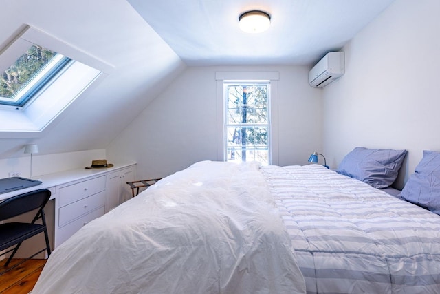 bedroom featuring vaulted ceiling with skylight, a wall mounted air conditioner, and wood finished floors