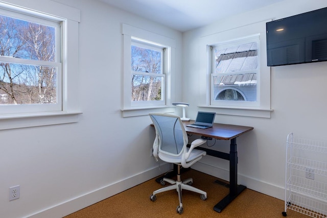 carpeted home office with baseboards