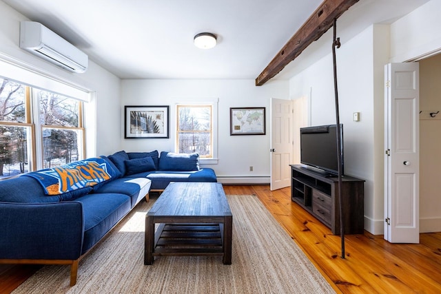 living area featuring baseboards, wood finished floors, baseboard heating, an AC wall unit, and beam ceiling