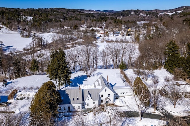 snowy aerial view with a mountain view