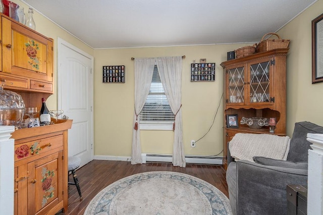 interior space featuring a baseboard heating unit, dark wood finished floors, and baseboards