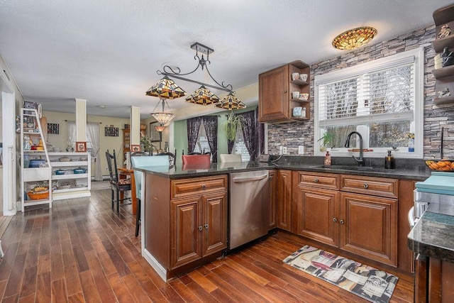 kitchen featuring brown cabinets, dishwasher, a peninsula, and a sink