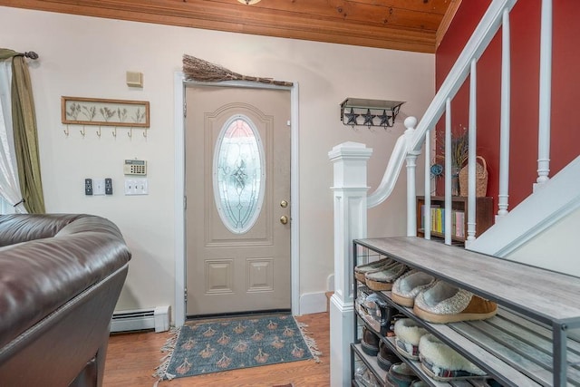 entryway with stairs, a baseboard radiator, wood finished floors, and wooden ceiling