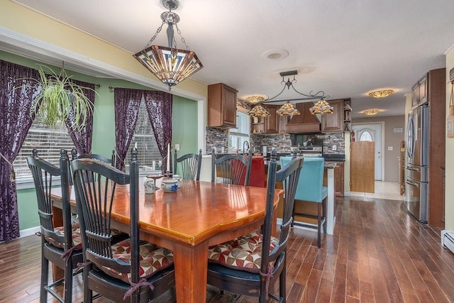 dining space with dark wood-style floors and baseboards