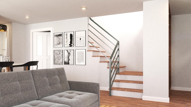 stairway featuring recessed lighting, wood finished floors, and baseboards