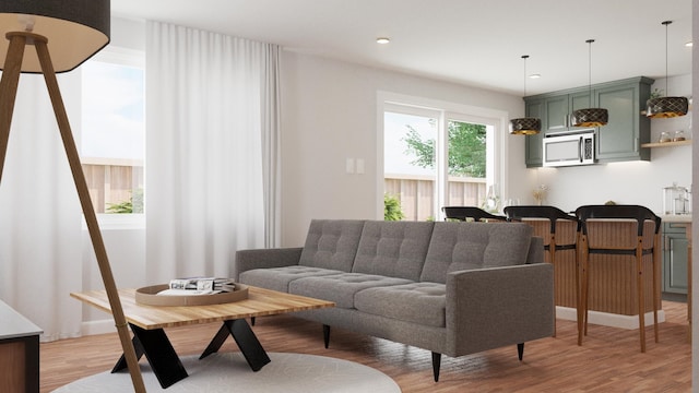 living room with light wood finished floors and recessed lighting