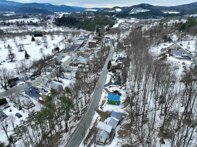 snowy aerial view featuring a mountain view