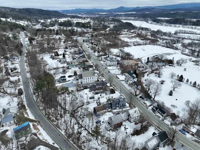 snowy aerial view with a mountain view