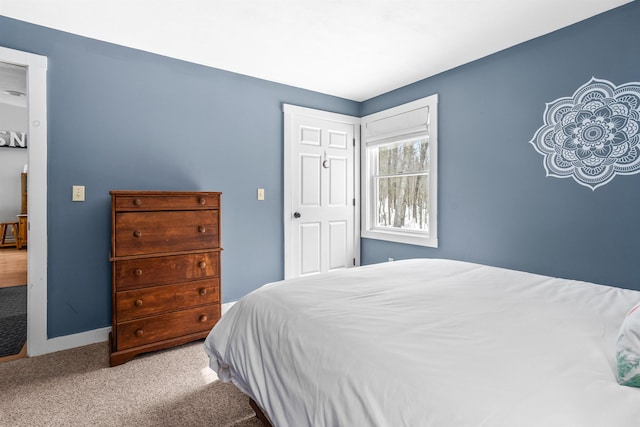 bedroom featuring carpet flooring and baseboards